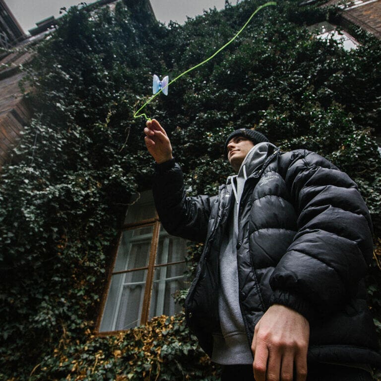 Skilled player performing with a yo-yo outdoors, showcasing precision and skill.