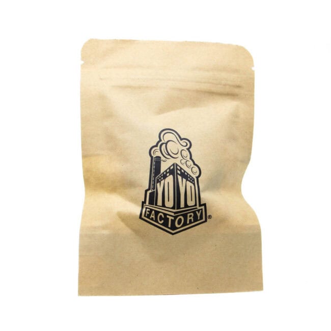 Packaging with YoYoFactory Europe logo on kraft paper bag, showcasing branding and product presentat.