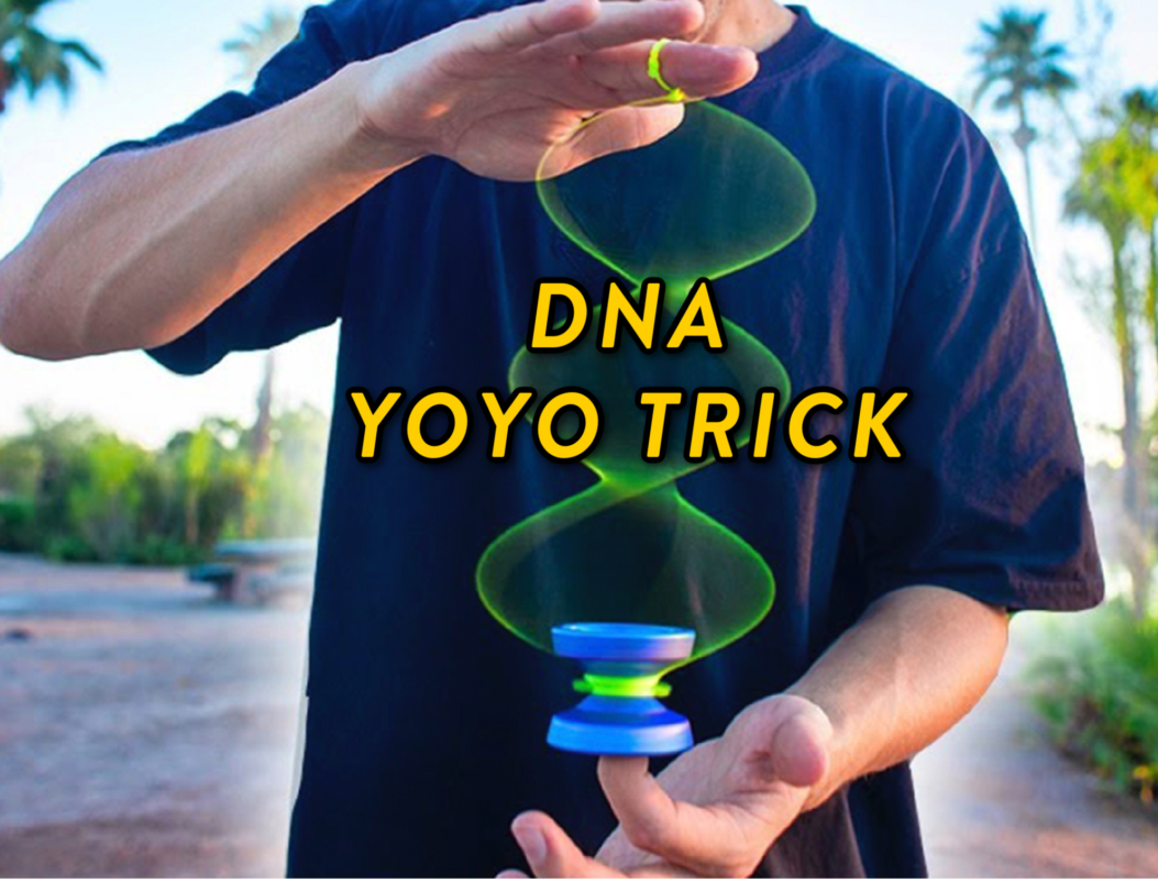 Person performing a DNA yo-yo trick outdoors with a blue and green yo-yo.
