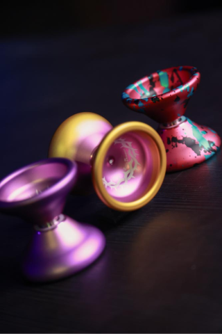 Colorful YoYos from YoYoFactory Europe on a dark surface.