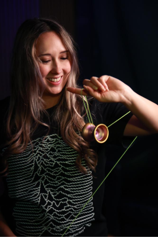 Young woman playing with a YoYoPrevail signature yoyo for skill and fun.