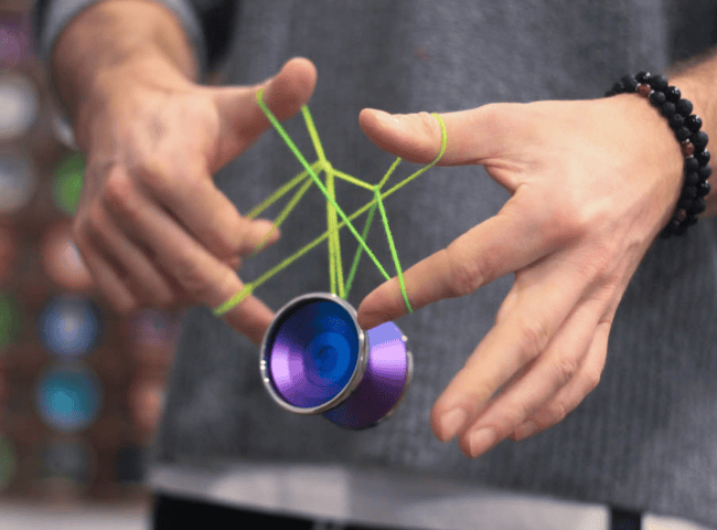 Person holding a yo-yo with a protective travel case for safe yoyo transport.